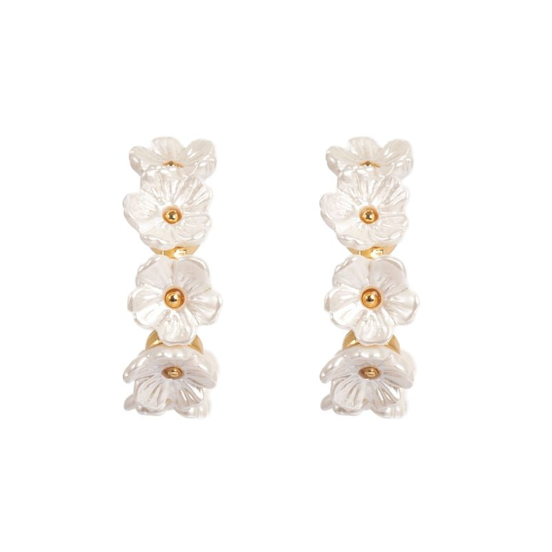 Gullfargede Tone Damli Seven Blooms øredobber med blomsterdesign, elegante og stilfulle til enhver anledning.